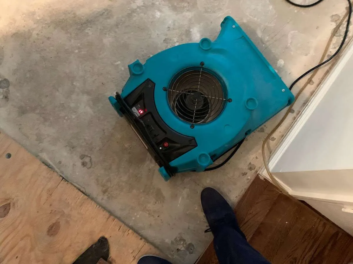 Air mover drying subfloor during Leak Detection & Repair in Penn Forest